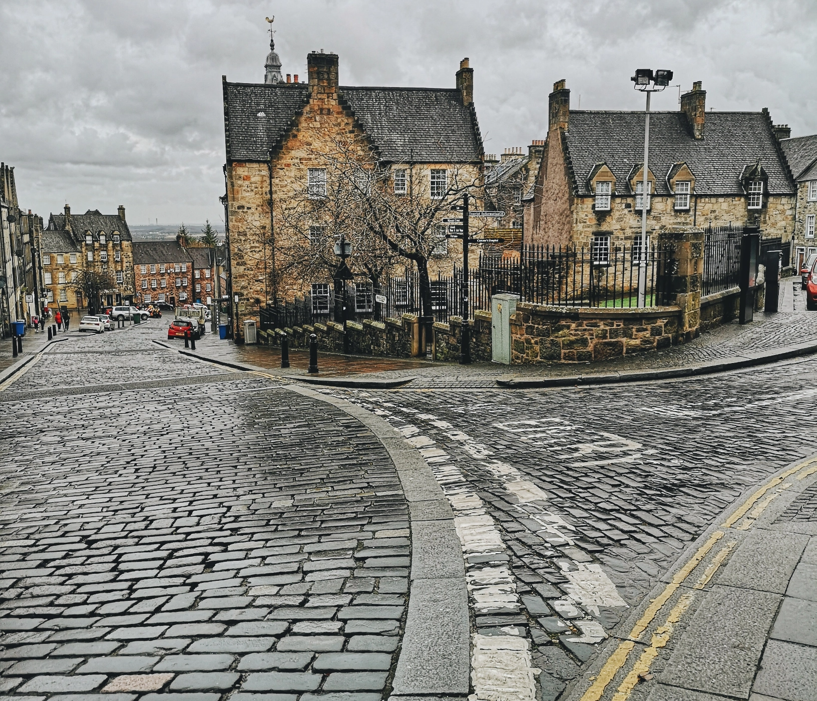 picturesque photo of a residential street in Edinburgh, Scotland with historical looking houses and a cobblestone street